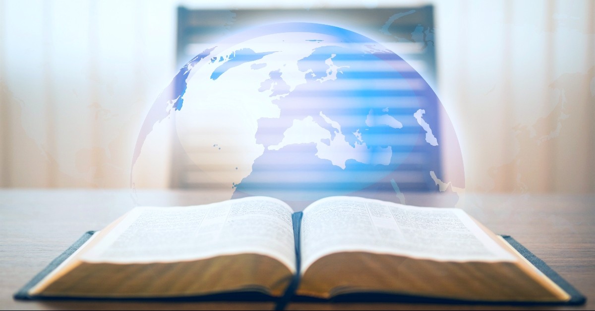 Bible opened with a globe on top