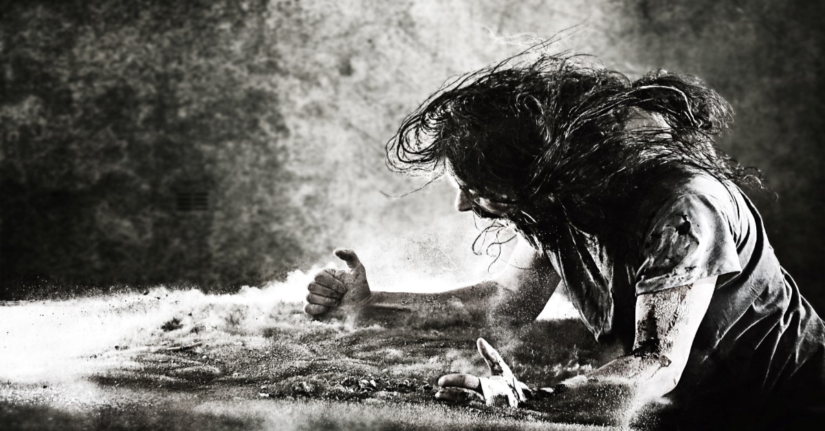 screaming wild man striking sandy ground