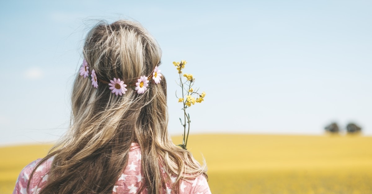 blonde woman in field with flower crown